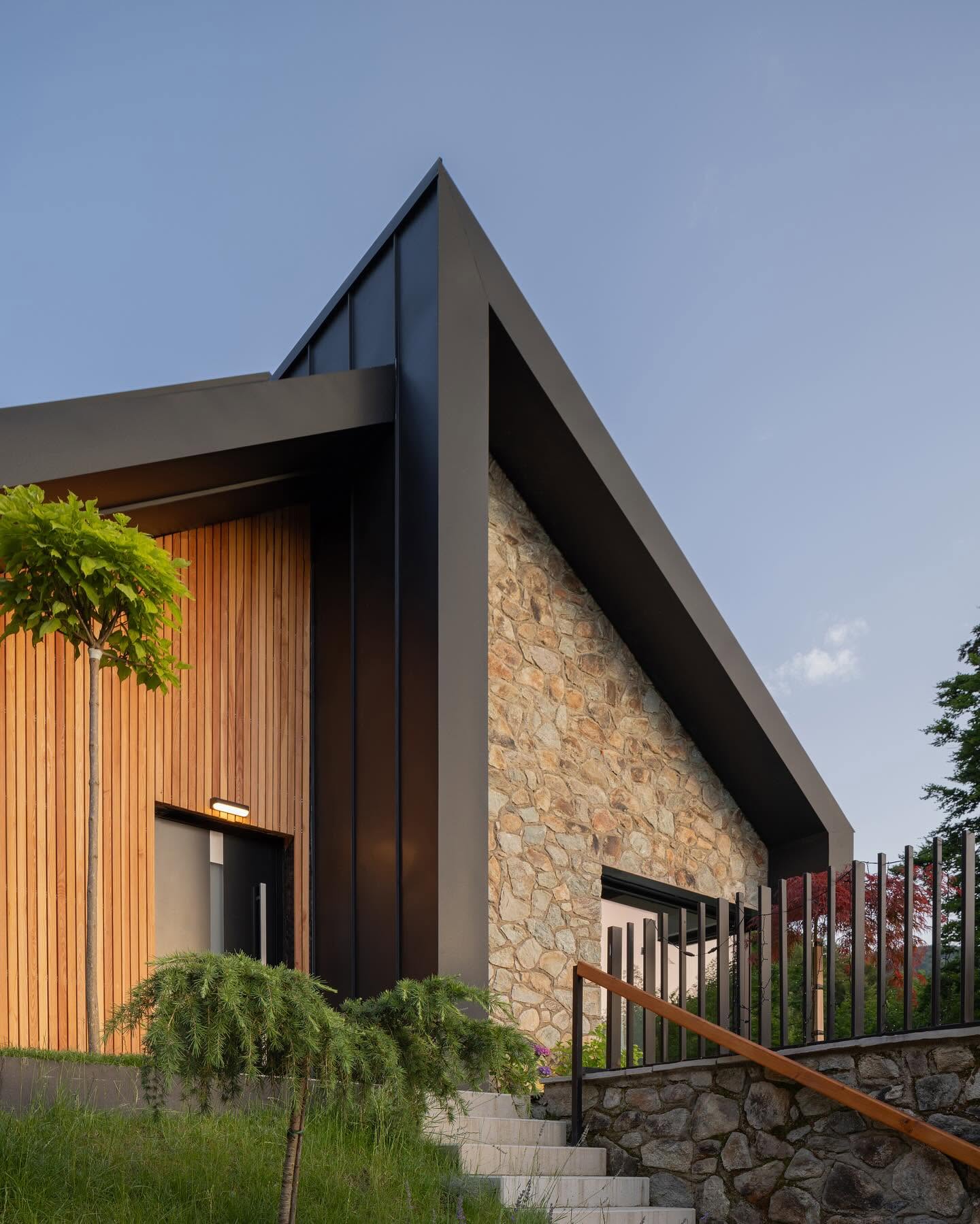 Brezovilla: a pitched roof framing a facade of stone and timber
